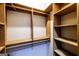 Walk-in closet with wooden shelving and hanging rods, offering ample storage space at 5780 Pumkintown Rd, Douglasville, GA 30135