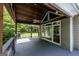 Covered deck featuring a ceiling fan and an outdoor view, creating a relaxing retreat at 5780 Pumkintown Rd, Douglasville, GA 30135