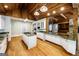 Gourmet kitchen features custom cabinets, granite countertops, stainless appliances, and wood beam ceiling at 5780 Pumkintown Rd, Douglasville, GA 30135
