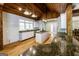 Bright kitchen features stainless appliances, granite countertops, kitchen island and wood beam ceiling at 5780 Pumkintown Rd, Douglasville, GA 30135