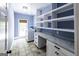 Laundry room featuring a washer, dryer, shelving, counter space, and tiled floors at 5780 Pumkintown Rd, Douglasville, GA 30135