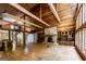 Inviting living room with stone fireplace, built-ins, spiral staircase, and wood beam ceilings at 5780 Pumkintown Rd, Douglasville, GA 30135
