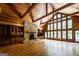 Open living room with a stone fireplace, built-in cabinetry, and large windows for natural light at 5780 Pumkintown Rd, Douglasville, GA 30135