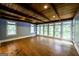 Living room with a wall of windows, wood flooring, wood ceilings, and natural light at 5780 Pumkintown Rd, Douglasville, GA 30135