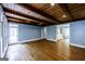 Spacious living room boasts wood floors, exposed beam ceiling, and ample natural light at 5780 Pumkintown Rd, Douglasville, GA 30135