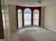 Cozy bedroom with arched windows, carpet flooring, and ample natural light at 9160 Woodhaven Way, Mcdonough, GA 30253