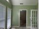 Bright sun room with tiled floors, large windows, and french doors at 9160 Woodhaven Way, Mcdonough, GA 30253