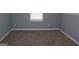 Bedroom showcasing neutral carpet, gray walls, and a window with blinds, offering a simple design at 74 Flanders Ct, Douglasville, GA 30134