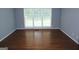 Bright, open bedroom featuring hardwood floors, neutral paint, and large window for natural light at 74 Flanders Ct, Douglasville, GA 30134