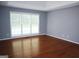 Spacious bedroom featuring hardwood floors, neutral paint and large windows for ample natural light at 74 Flanders Ct, Douglasville, GA 30134