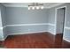 Spacious dining room with hardwood floors, neutral paint and decorative lighting at 74 Flanders Ct, Douglasville, GA 30134