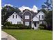 Charming two-story home with stone accents, a well-manicured lawn, and mature landscaping at 74 Flanders Ct, Douglasville, GA 30134