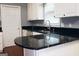 Stylish kitchen with dark granite countertops, stainless steel appliances, and white cabinets at 74 Flanders Ct, Douglasville, GA 30134