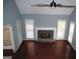 Bright living room with stone fireplace, hardwood floors, and large windows for ample natural light at 74 Flanders Ct, Douglasville, GA 30134