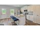 Well-lit kitchen features granite countertops, white cabinets, stainless steel appliances, and a stylish island at 8747 Lakeview Commons # 1, Jonesboro, GA 30238