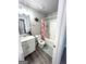 Bright bathroom featuring a shower-tub combo and modern fixtures at 7728 Fawn Cir, Covington, GA 30014