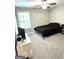 Simple bedroom featuring a dark bedset, neutral walls, carpet floors, and a ceiling fan at 7728 Fawn Cir, Covington, GA 30014