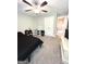 Carpeted bedroom features a ceiling fan, closet doors, and neutral paint at 7728 Fawn Cir, Covington, GA 30014