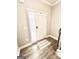 Front door entrance with small window, interior view featuring modern wood floors and a gray and white rug at 7728 Fawn Cir, Covington, GA 30014