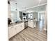 Open concept kitchen featuring stainless steel appliances, island sink, granite countertops, and light wood floors at 7728 Fawn Cir, Covington, GA 30014
