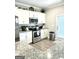 Functional kitchen with stainless steel appliances and ample cabinet space at 7728 Fawn Cir, Covington, GA 30014