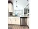 Well-lit kitchen features stainless steel appliances and an island sink with open view to the dining room at 7728 Fawn Cir, Covington, GA 30014