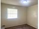 Neutral bedroom space with plush carpet, a bright window, and crisp, clean walls at 443 S Rays Rd, Stone Mountain, GA 30083