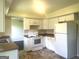Bright kitchen featuring white cabinetry, modern appliances, and durable countertops at 443 S Rays Rd, Stone Mountain, GA 30083
