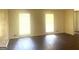 Sunlit living room featuring gleaming hardwood floors and bright windows at 443 S Rays Rd, Stone Mountain, GA 30083