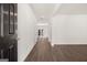 Hallway features hardwood floors, white walls, and natural light from the back doors at 608 Whitman Lane # 2028, Stockbridge, GA 30281