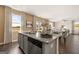 Open concept kitchen with granite island, stainless appliances, and view of the backyard at 608 Whitman Lane # 2028, Stockbridge, GA 30281