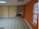 Spacious basement room featuring a stone fireplace and window at 5700 Miles Rd, South Fulton, GA 30349