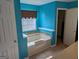 Relaxing bathroom featuring a jetted tub and tiled accents at 5700 Miles Rd, South Fulton, GA 30349