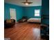 Bedroom showcasing wood laminate flooring, ceiling fan, and a pair of windows at 5700 Miles Rd, South Fulton, GA 30349