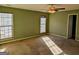 Carpeted bedroom with ample natural light from two windows with a ceiling fan at 5700 Miles Rd, South Fulton, GA 30349