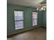 Bedroom features two windows, a ceiling fan and neutral colored carpeting at 5700 Miles Rd, South Fulton, GA 30349