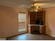 Bedroom featuring a built-in desk with shelving, neutral paint, ceiling fan and window at 5700 Miles Rd, South Fulton, GA 30349