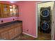 Convenient laundry room with built-in cabinets and modern washer and dryer units at 5700 Miles Rd, South Fulton, GA 30349