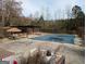 Large outdoor pool area with a covered patio and plenty of space for entertaining at 5700 Miles Rd, South Fulton, GA 30349