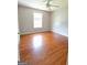 Sunlit bedroom features lustrous hardwood floors and a large window, creating a warm ambiance at 5113 Heritage Oaks Sw Ln, Powder Springs, GA 30127