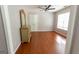 Bright bedroom features hardwood floors, a ceiling fan, and natural light from a large window at 5113 Heritage Oaks Sw Ln, Powder Springs, GA 30127