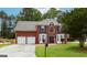 Charming two-story brick home with well-manicured lawn and two-car garage in a residential area at 5113 Heritage Oaks Sw Ln, Powder Springs, GA 30127