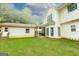 Back exterior of home showcasing a spacious yard, covered patio, and ample natural light at 5113 Heritage Oaks Sw Ln, Powder Springs, GA 30127