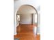 Bright living room with hardwood floors, wainscotting, and archway at 5113 Heritage Oaks Sw Ln, Powder Springs, GA 30127