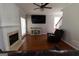 Cozy living room with fireplace, entertainment center, ceiling fan and hardwood floors at 5113 Heritage Oaks Sw Ln, Powder Springs, GA 30127