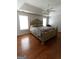 Spacious main bedroom with tray ceiling, ceiling fan, hardwood floors, and natural light at 5113 Heritage Oaks Sw Ln, Powder Springs, GA 30127