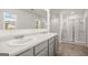 Bright bathroom with double sink vanity, walk-in shower, tile flooring, and large mirror at 624 Whitman Lane # 2032, Stockbridge, GA 30281