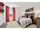 Charming bedroom with hardwood furniture, red curtains, and sporty decor, designed for comfort and personality at 624 Whitman Lane # 2032, Stockbridge, GA 30281