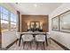 Bright dining room with modern decor, featuring a large window and stylish furnishings at 624 Whitman Lane # 2032, Stockbridge, GA 30281