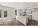 Kitchen featuring stainless appliances, island with sink, gray cabinets, and backyard access at 624 Whitman Lane # 2032, Stockbridge, GA 30281
